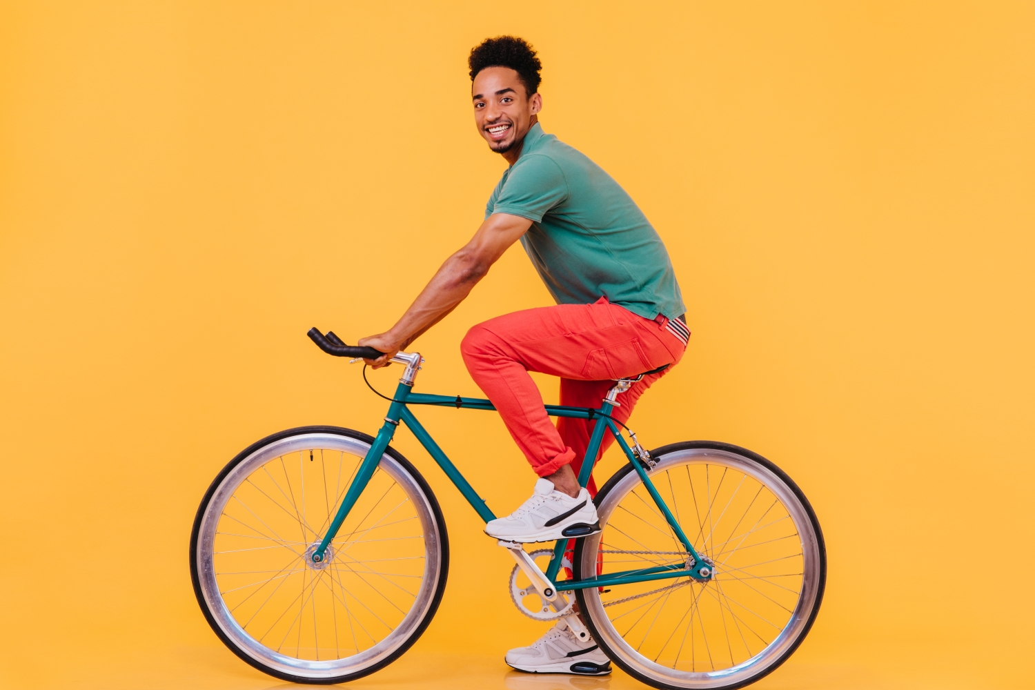 Persoon op fiets op gele achtergrond